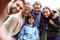 Theyre a close-knit family. a multi-generational family posing for a self-portrait.