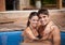 Theyre enjoying their holiday together. Portrait of an attractive couple embracing in a pool.
