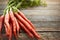 Theyre an excellent source of vitamins, nutrients, and fibre. a bunch of fresh carrots on a table.