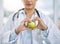 Theyre good for you if theyre good for your heart. Closeup shot of an unidentifiable doctor holding an apple.