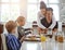 Theyre one happy family. a family having breakfast together.