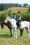 Theyre ready for some serious horse riding. Portrait of two young women on horseback outside.