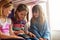 Theyre taking turns to play their favourite games online. Cropped shot of a group of little girls using a digital tablet