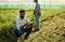 Theyve both got a job to do. Full length shot of a handsome young male farmer using a tablet while working on his farm