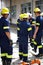 Theyve got the situation under control. Shot of a group of firemen standing outside a fire station.