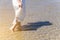 Theâ€‹ Low angle behind woman walking barefoot on beach