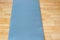 Thick anti slip blue fitness yoga practice or meditation mat on