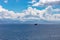 Thick clouds over the calm Ionian Sea as the ship sails along the coast of the island of Corfu, Greece