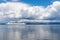 Thick clouds over the calm Ionian Sea as the ship sails along the coast of the island of Corfu, Greece