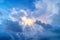 Thick cumulus clouds and bright blue sky.