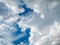 Thick cumulus clouds with a deep blue sky making their way through