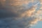 Thick Cumulus clouds lit on one side by the setting sun