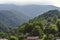 Thick fog covers the mountains with forest and the chapel of St. Sarkis in the village of Gosh, located near the town of Dilijan