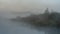 thick fog over a river with overgrown banks in the morning twilight in a swampy area. widescreen format 16:9