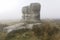Thick fog surrounds the Eagle Stone on Eagle Stone Flat near Baslow Edge in Derbyshire