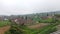 thick foggy sky over the countryside with fields and traditional Indonesian houses with tiled roofs called joglo