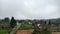 thick foggy sky over the countryside with fields and traditional Indonesian houses with tiled roofs called joglo