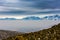 Thick Layer of Smog With Snow Capped Mountains In Background