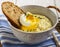 Thick mashed potatoes with poached egg and a slice of bread thyme