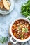 Thick minced meat soup with tomatoes, beans, chickpeas and vegetables. Healthy dinner. View from above. Copy space. top view