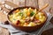 Thick potato soup with sausages and parsley in a bowl with bread