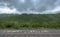 Thick Rain Clouds Cover Mountain Tops along Gravel Road