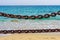 Thick rusty chains with the sea in the background