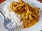 Thick, salty and sweet coconut cream Thai red curry with pork  Panang Moo  on soft white rice