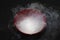 Thick Smoke from dry ice in a bowl, black background