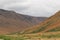 Thick summer clouds loom over an expanse of the stark rocky beauty of the Tablelands ophiolite Gros Morne National Park Canada