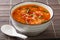 Thick tomato egg drops soup or Chinese flower soup close-up in a bowl. horizontal