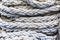 Thick twisted gray ship`s mooring rope close up
