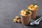 Thick vegan pumpkin cream soup with seeds and croutons in disposable cups of craft paper. Soup to go. Healthy food delivery. Take