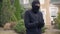 Thief in black clothes and balaclava before breaking into house. The guy going to steal things in rich house. Concept of