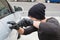 Thief breaking into car with screwdriver