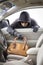 Thief stealing handbag from car