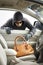 Thief stealing wallet from car