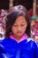 Thimpu , Bhutan - September 2010: Portrait of a shy young Bhutanese girl with crowd scene background