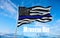 Thin Blue Line. Black Flag of USA with Police Blue Line waving in the wind on flagpole against the sky with clouds on sunny day