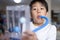 Thin boy uses a Tri-ball Incentive Spirometer for check his lung function