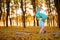 .Thin brunette girl  standing in headstand exercise, Garuda salamba sirsasana pose in autumn park on a sunset background. Woman