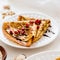 Thin Crepes with melted chocolate, sesame seeds, pomegranate and almonds