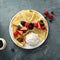 Thin crepes with whipped cream and berries