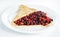 Thin delicious pancake with berries on white