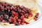 Thin delicious pancake with berries on white