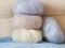 Thin fluffy skeins of wool for knitting a pale pink, blue and be