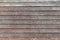 Thin horizontal wooden texture wall of rural house. Old dirty panels background