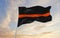 Thin Orange Line flag waving at sky background on sunset, panoramic view. copy space for wide banner. SAR First Responders,