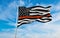 Thin Orange Line USA flag waving at sky background on sunset, panoramic view. copy space for wide banner. SAR First Responders,