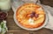 Thin pancakes with cherries. Pancakes in a white plate. Wood background. Sweet food